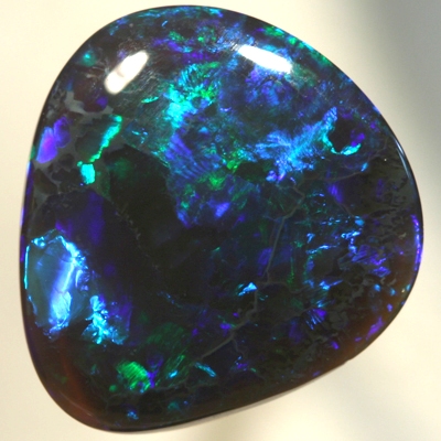 SOLID BLACK CRYSTAL OPAL Bright greens play over a background hue of purple blue SEE VIDEO